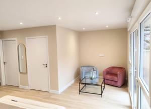 a living room with a chair and a glass table at Domaine de la Brême  +3 photos