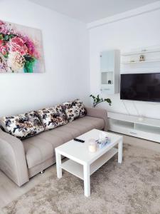 a living room with a couch and a coffee table at Sibiu Edge Retreat in Sibiu