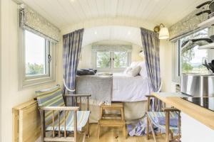 a bedroom with a bed and a table and chairs at 1 Bed in Leintwardine oc-b29785 in Brampton Bryan +9 photos