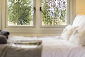 a white bed with two windows in a room at 1 Bed in Leintwardine oc-b29785 in Brampton Bryan