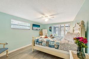 a bedroom with a bed and a ceiling fan at Cozy Oasis Screened Pool Picturesque Water Canal Views! in Port Richey