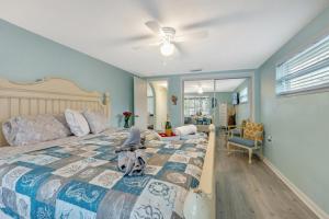 a bedroom with a bed with a dog sitting on it at Cozy Oasis Screened Pool Picturesque Water Canal Views! in Port Richey +57 photos