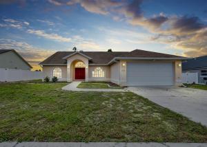 a house with a garage with a red door at Pool Waterfront Lake 12 PPL Gorgeous in Riverview