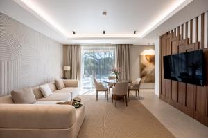 a living room with a couch and a table at Almyros Beach in Acharavi