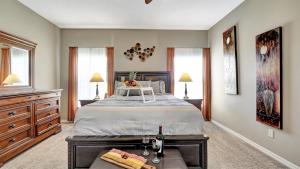 a bedroom with a large bed and two windows at Valrico's Hidden Gem A Stunning 3-Bedroom Oasis Awaits! in Valrico