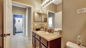 a bathroom with a sink and a mirror at Valrico's Hidden Gem A Stunning 3-Bedroom Oasis Awaits! in Valrico +50 photos