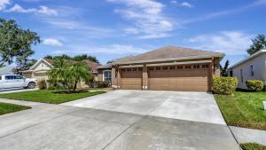 a large house with a garage at Valrico's Hidden Gem A Stunning 3-Bedroom Oasis Awaits! in Valrico