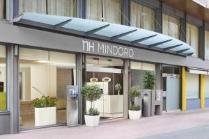 a store front of a building with potted plants at NH Castellón Mindoro in Castellón de la Plana
