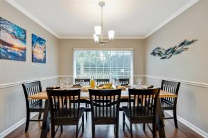 a dining room with a wooden table and chairs at Exquisite Retreat with Heated Pool for 14 Guests, Pool Table Paradise! in Brandon
