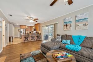 a living room with a couch and a table at Exquisite Retreat with Heated Pool for 14 Guests, Pool Table Paradise! in Brandon +59 photos
