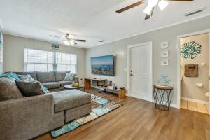 a living room with a couch and a ceiling fan at Exquisite Retreat with Heated Pool for 14 Guests, Pool Table Paradise! in Brandon