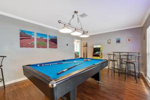 a living room with a pool table and bar at Exquisite Retreat with Heated Pool for 14 Guests, Pool Table Paradise! in Brandon