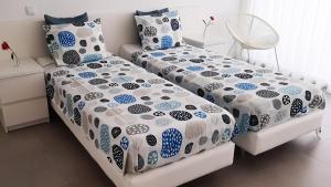 En eller flere senge i et værelse på Villa Pescaria