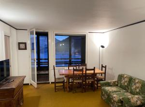 a living room with a dining room table and a couch at We ski Matese in San Massimo