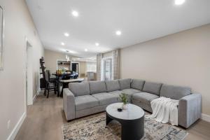 a living room with a couch and a table at Luxe Getaway w Pool, Games & Fun Vibes in Palm Harbor