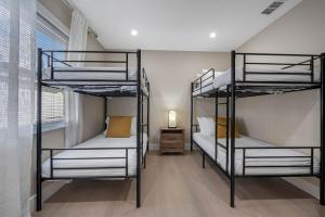 two bunk beds in a room with a window at Luxe Getaway w Pool, Games & Fun Vibes in Palm Harbor +91 photos