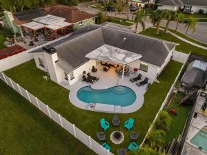 an overhead view of a house with a swimming pool at Luxe Getaway w Pool, Games & Fun Vibes in Palm Harbor