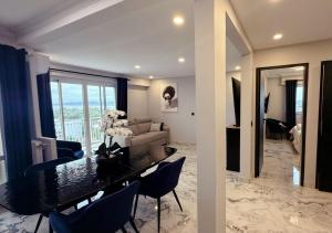 een woonkamer met een tafel met stoelen en een bank bij Panorama Majestic in Saint-Raphaël