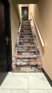 a stairway with wooden steps and a black door at Amigo Hotel in Amsterdam