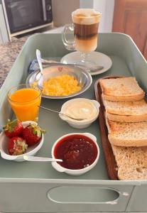a tray of breakfast food with toast and a drink at Piccolo Posto in Neuquén
