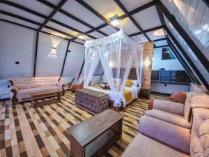 a living room with a bed and a couch at White Moon Cabin & Cottage in Ella