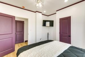 une chambre avec deux portes violettes et un lit dans l'établissement 7 Mi to Philly Stadiums! Charming Apartment, à Darby