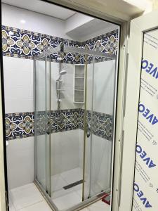 a shower with a glass door in a bathroom at Apartment city in Baku