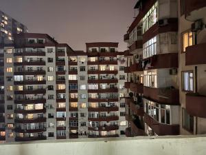 an apartment building with its lights on at night at Apartment city in Baku