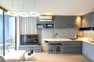 a kitchen with a couch and a table in a room at The Kamala View in Kamala Beach +87 photos