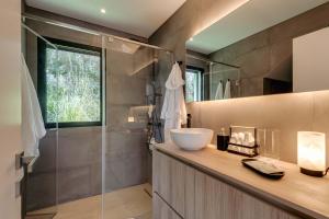 a bathroom with a sink and a shower at Ocean & Pool Retreat Villa by HostWise in Amoreira