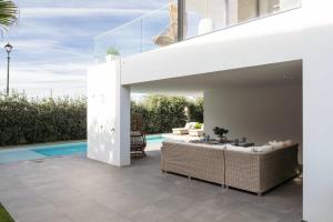 a modern house with a swimming pool and a patio at Ocean & Pool Retreat Villa by HostWise in Amoreira
