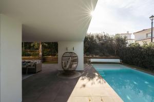 a house with a swimming pool in a yard at Ocean & Pool Retreat Villa by HostWise in Amoreira +43 photos
