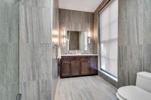 a bathroom with a sink and a toilet and a mirror at The Founders Suite Residence in Philadelphia +48 photos