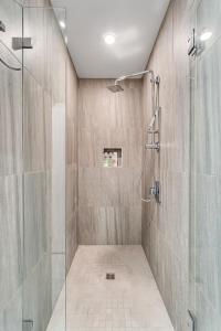 a bathroom with a shower with a glass door at The Founders Suite Residence in Philadelphia