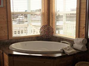 a bath tub sitting next to a window in a room at Westport Marina Cottages in Westport
