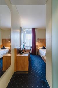 Ένα ή περισσότερα κρεβάτια σε δωμάτιο στο Hotel Gustav-Stresemann-Institut