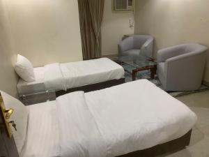 Postel nebo postele na pokoji v ubytování سرايا سين للشقق المخدومة