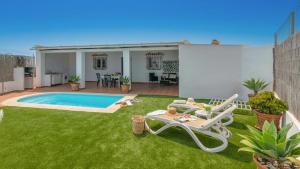 einen Hinterhof mit Pool und Rasenflächen in der Unterkunft Villa Paraiso Torrox by Ruralidays in Torrox