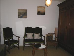 a living room with two chairs and a table at Le MONSEG in La Celle-sous-Gouzon