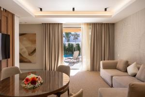 a living room with a couch and a table at Almyros Beach in Acharavi