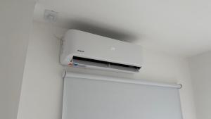 a white printer sitting on top of a wall at Temporario Sur, hasta 4 personas con 3 camas, General Roca in General Roca