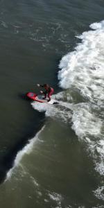a man riding a wave on a surfboard in the water at Totora Surf Hostel in Huanchaco