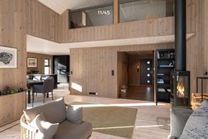 a living room with a couch and a fireplace at Trysilfjell hytteomrade 2124 by Vacation Trysil in Hovi
