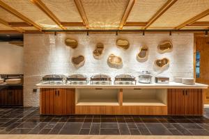 a kitchen with a counter with shoes on the wall at Klyra Hotel in Hyderabad +29 photos
