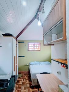 a small room with two beds and a table at Karaguashouse in Florianópolis