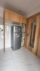 a kitchen with a stainless steel refrigerator in a room at F3 2 Chambres Piscine Residence Point E in Dakar