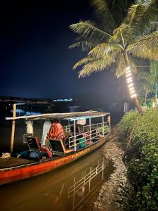 a boat on the water with people on it at Kadingis homestay and eco tourism in Kadalundi