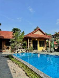a swimming pool in front of a house at Trang An ViewPoint Homestay in Ninh Binh