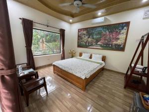 a bedroom with a bed and a large window at Trang An ViewPoint Homestay in Ninh Binh
