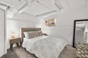 a white bedroom with a bed and a mirror at Downtown location Near the Beach Dog Friendly in Edmonds